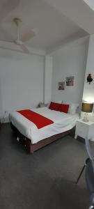 a bedroom with a large bed with red pillows at Casablanca 4 in Tacna