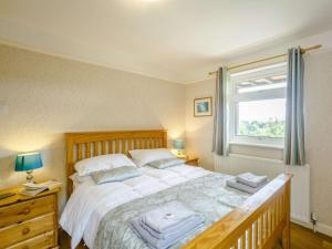 a bedroom with a large bed and a window at 3 bed in Rothbury 63025 in Rothbury