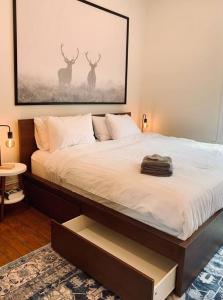 a bedroom with a bed with two deer paintings on the wall at Pet-Friendly Space #3 at Doggy Digs, King Bed and Office in Halifax +36 photos