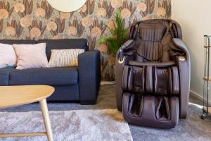 a suitcase sitting in a living room next to a couch at 3 Bedroom Hagley Park Paradise in Christchurch