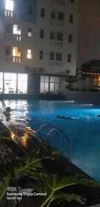 a swimming pool with a building in the background at Urbantown Serpong in Dukuh