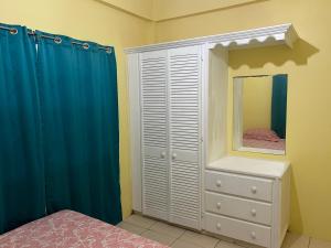 a bedroom with a white dresser and a mirror at Estuary Apartment 2 in Dunfermline