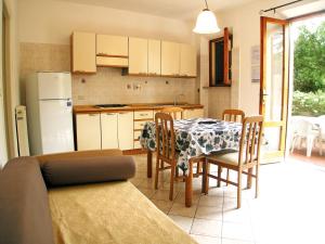 a kitchen and dining room with a table and chairs at L' Oleandro in Marina di Campo