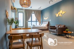 a living room with a table and chairs and a couch at Highpark Suites at Petaling Jaya, Kelana Jaya by Plush in Petaling Jaya