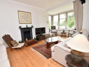 a living room with a couch and a fireplace at 4 Bed in Lulworth Cove DC182 in West Lulworth