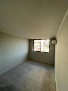 an empty room with a window in an empty house at Departamento Cómodo en Santiago in Santiago