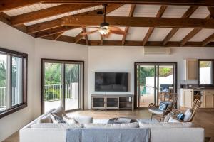 a living room with a couch and a tv at Private Oasis with Incredible Views in Nazareth