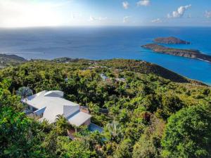 an aerial view of a house on a hill next to the ocean at Private Oasis with Incredible Views in St Thomas