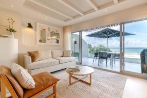 a living room with a couch and a view of the ocean at Netanya Noosa in Noosa Heads