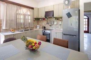 een keuken met een tafel en een fruitschaal bij Nature's Playground Cottage new listing2024 in Chania