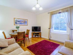 a living room with a couch and a table at 2 Bed in Keswick 86100 in Keswick