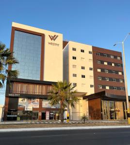 a building with a sign on the side of it at Studio cama King Size Westfit. in Mossoró