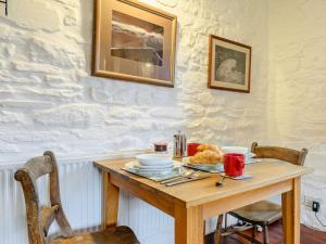 a wooden table with a plate of food on it at 1 bed in Cantref BN264 in Brecon