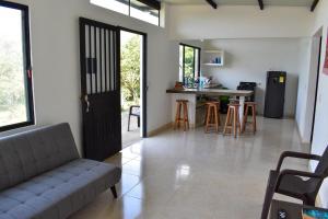 a living room with a couch and a table at Piedras del Sol Casa Campestre in Guaduas