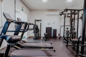 a gym with several tread machines in a room at Apê confortável com garagem e espaço de trabalho in Cuiabá