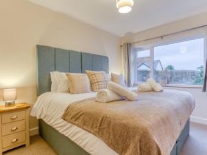 a bedroom with a large bed with a large window at 4 Bed in Parkham 76452 in Parkham