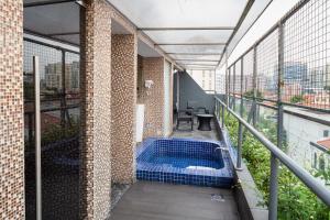 - un balcon avec un bain à remous au-dessus d'un bâtiment dans l'établissement Lion Peak Dickson, à Singapour