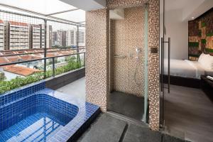 a bathroom with a shower and a swimming pool at Lion Peak Dickson in Singapore