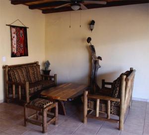 a room with a wooden table and two chairs at Les 3 Marulas in Marloth Park