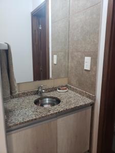 a bathroom counter with a sink and a mirror at ALTOS DE ALEM in Alta Gracia