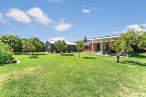 a house with a yard in front of a building at Belle Escapes - Bountiful Family Oasis in West Beach in Henley Beach South