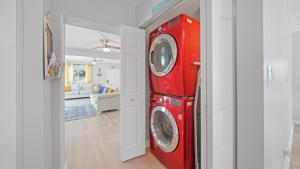 a red washer and dryer in a living room at Jacksonville Beach Home - Walk to Beach, Bars & Restaurants - Pet Friendly in Jacksonville Beach