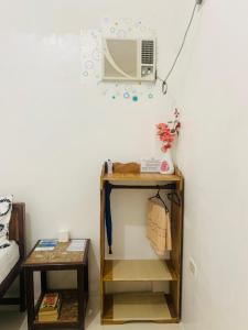 a room with a table with a fan on a wall at Queen's Room Rental 2 in El Nido