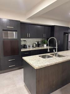 a kitchen with a sink and a microwave at Urban Circunvalación in Guadalajara
