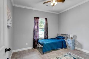 a bedroom with a blue bed and a window at Reduced! Renovated hidden gem. Chef Kitch. Wheelch in Beaumont