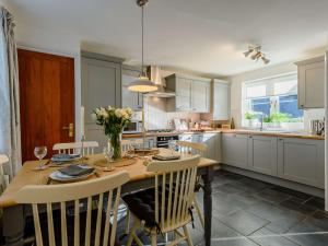 a kitchen with a table with chairs and a dining room at 3 Bed in Sway 90002 in Sway
