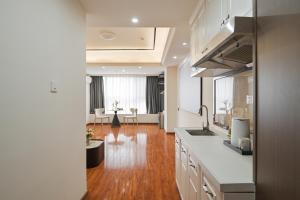 a kitchen with a sink and a counter top at East Maple International Apartment - Guangzhou Luogang Wanda Plaza Suyuan Metro Station in Guangzhou
