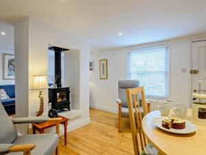 a living room with a table and a fireplace at 2 Bed in Long Melford 81320 in Long Melford