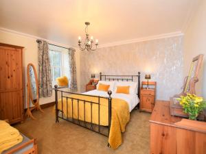 a bedroom with a bed and a chandelier at 3 Bed in Ennerdale SZ392 in Ennerdale Bridge