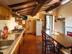 a kitchen with a counter top and a refrigerator at Belvilla by OYO Buffardello del Colle in Fornovolasco