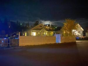 a house behind a fence at night with lights at The Flat Spot in Princeton