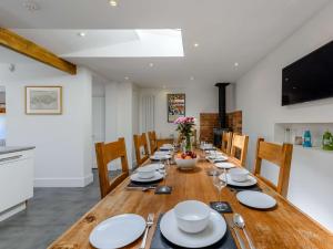uma sala de jantar com uma longa mesa de madeira e cadeiras em 5 bed in Pett Level 72495 em Pett