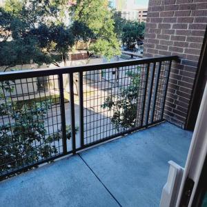 a balcony with a black fence and a sidewalk at Downtown Dream Toyota Ctr/George R Brown/Minute Maid Stadium in Houston