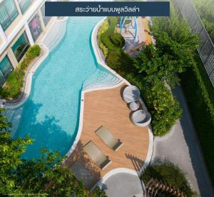 an overhead view of a swimming pool in a resort at Resort Style Condo Suksawat 64 Bangkok ND in Ban Tha Hin