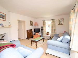 a living room with a couch and a tv at 3 bed property in Mundesley KT043 in Mundesley