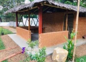 a small house with a straw roof at Vintage River View Villa in Panadura