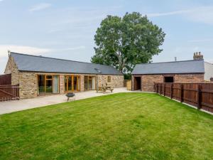 an external view of a stone house with a large yard at 2 Bed in Bishop Auckland 83829 in Wolsingham