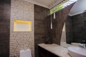 a bathroom with a sink and a toilet and a mirror at Medana Bay Marina in Paloh +28 photos