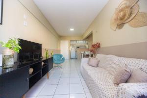 uma sala de estar com um sofá e uma televisão de ecrã plano em Apartamento Perto da BEIRA MAR. em Fortaleza