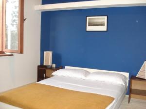 a bedroom with a blue wall and a bed at Apartments Mia in Starigrad-Paklenica