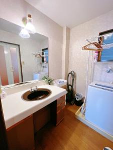 a bathroom with a sink and a large mirror at 大阪市東成区一軒家貸し切りファミリー向け小型車のみ無料駐車場可Private for families, small car free parking独栋可停小车 in Osaka +37 photos