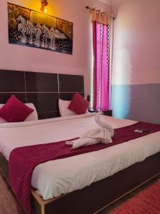 a bedroom with a large bed with purple curtains at Hotel golden gate dx in New Delhi