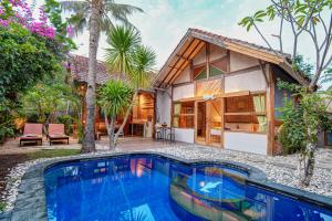 a house with a swimming pool in front of a house at Villas SAMALAMA Gili Air in Gili Air