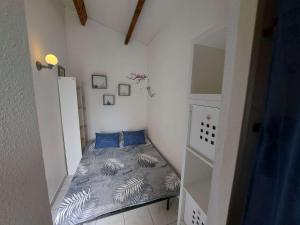 馬爾塞揚的住宿－Appartement Marseillan-Plage, 2 pièces, 6 personnes - FR-1-326-798，小卧室配有带蓝色枕头的床