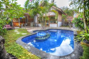 a swimming pool in the yard of a house at Villas SAMALAMA Gili Air in Gili Islands