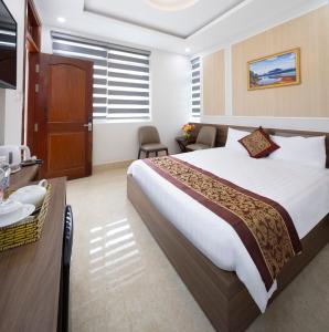 Postel nebo postele na pokoji v ubytování ROMANCE HOTEL DALAT